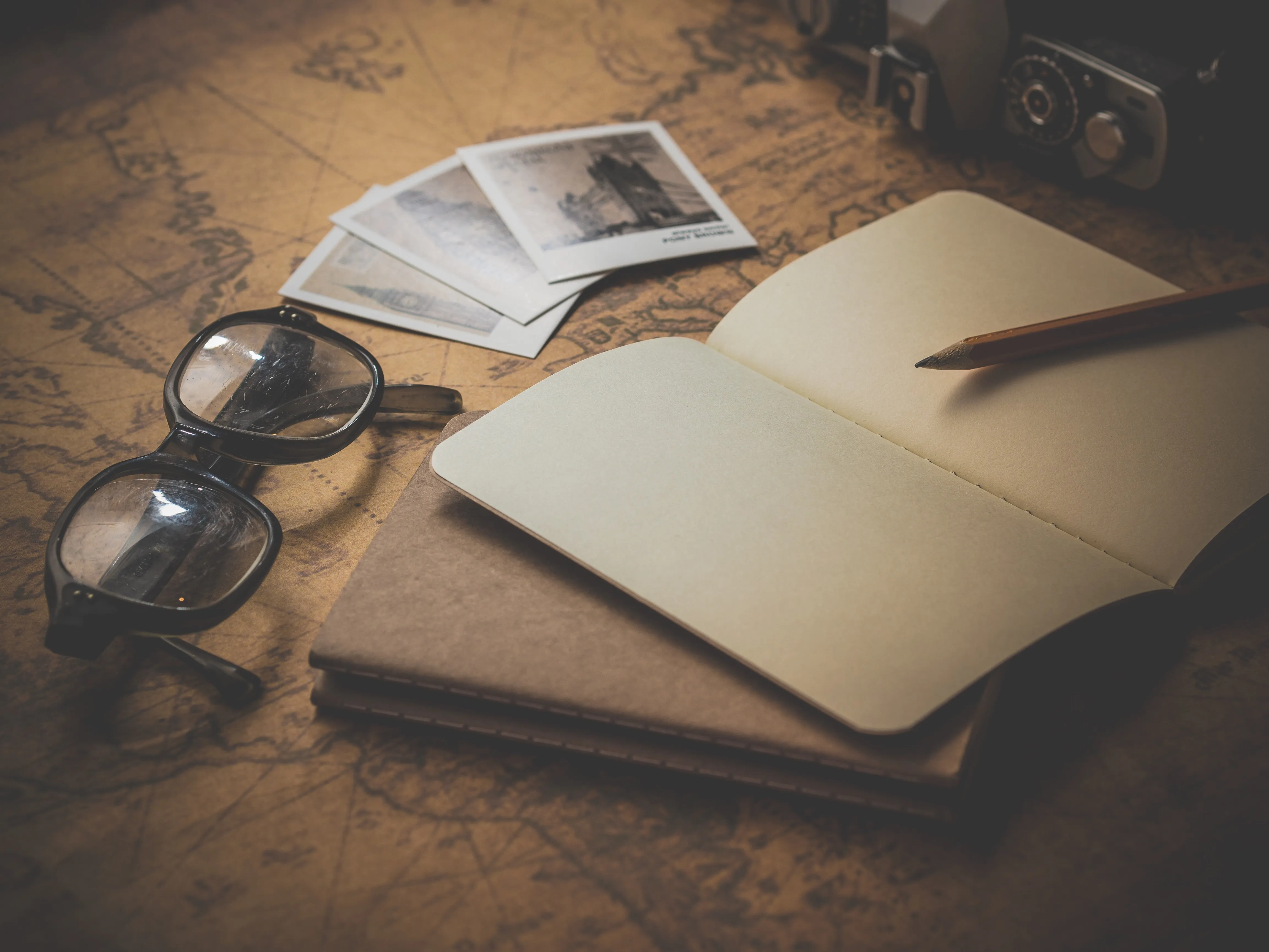 Map, eyeglasses, and notebook.